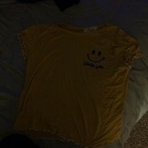 A yellow cute shirt with a smiley face on it